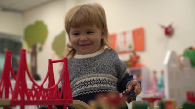 4K Toy road and bridge in the nursery children's room, the child plays with enthusiasm