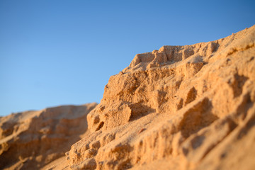 Fototapeta na wymiar Desert, sandy barkhans over background of blue sky 
