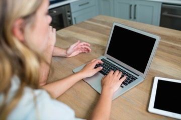 Couple using laptop and tablet