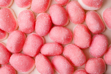 Pink jellies or marshmallows as background