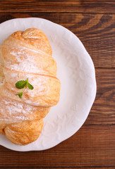 croissants for breakfast on a white plate