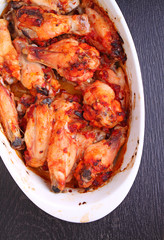 Chicken wings fried in tomato sauce