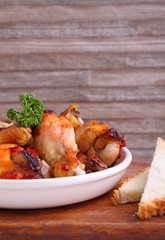 Chicken wings fried with spices in tomato sauce