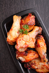 Chicken wings fried with spices in tomato sauce