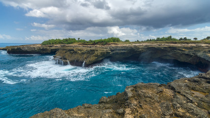 Waves on the rocks near the island of Lembongan near Bali