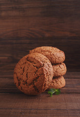 oatmeal cookies on a dark wooden background