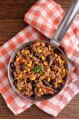 minced meat with corn, sweet peppers and beans in a dish