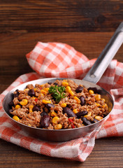 minced meat with corn, sweet peppers and beans in a dish