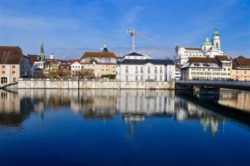 Fototapeta na wymiar Schweizer Stadt Solothurn im Winter, am Fluss Aare, mit Altstadt und Fischergasse. Rechts Kreuzackerbrücke und St. Ursen Kathedrale 