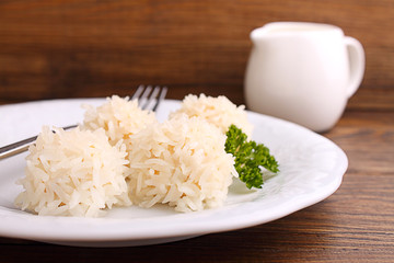 hedgehogs, chicken cutlet with rice on a plate on a dark background