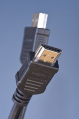 Macro of cables standard HDMI with selective focus on blue background