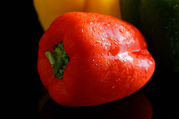 colorful peppers over dark background