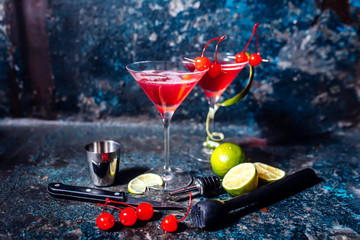 cosmopolitan cherry martini cocktail, served cold with lime and ice - obrazy, fototapety, plakaty