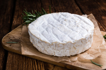 Creamy Camembert on wooden background