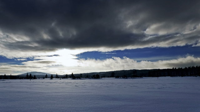 Time-lapse of moving clouds over snow field in mountains, National Park Sumava in Czech Republic, 4K