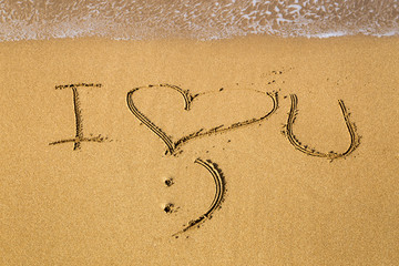 I Love You message written in sand; summer background, sea and sand background
