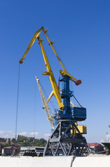 Fototapeta na wymiar harbour cranes on loading in sea port