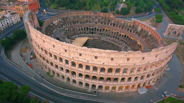 Colosseum, Rome, Italy. Aerial Roman Coliseum on sunrise. Beautiful view of the famous Italian landmark travel icon in the Roman forum.