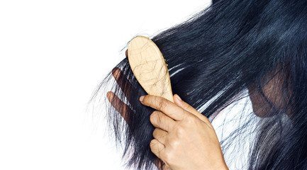 woman losing hair as she brush on hairbrush