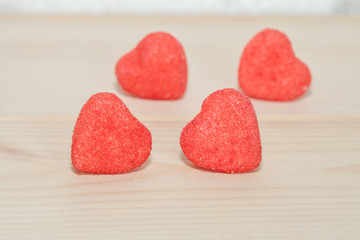 Fototapeta na wymiar heart candies coated with sugar sitting on