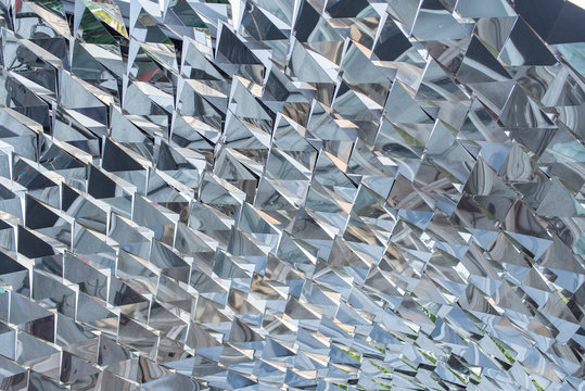 Mirror sculpture in diamond-shape on background