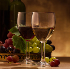 Red and white wine glasses and grape