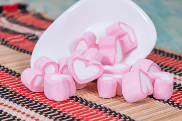 Colorful sweet marshmallow with sugar in a white-ware