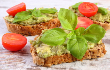 Freshly sandwiches with paste of avocado and ingredients, healthy food and nutrition
