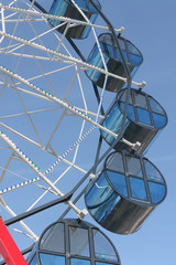 Cabins the ferris wheel against the blue sky