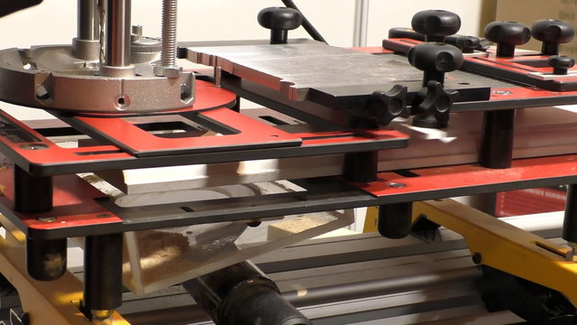 Man cutting wooden scribes using carpenters machinery tool, the scribing jig