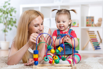 happy kid girl and mom playing toy