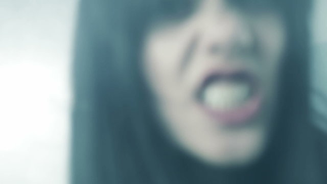 Beautiful woman zombie attacking camera angry