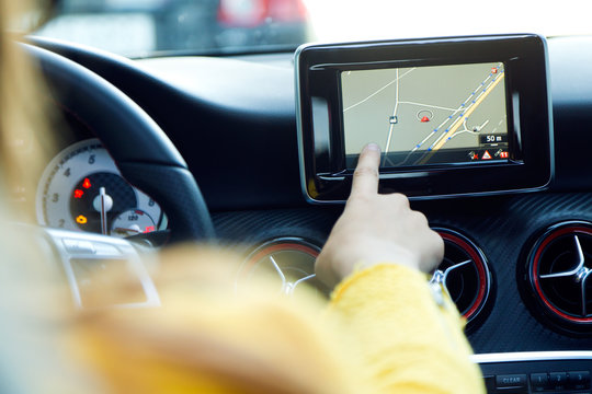 Woman Using a GPS Navigation System in a Car