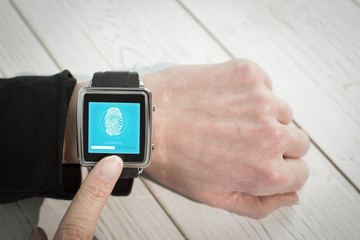 Composite image of businesswoman using a smart watch