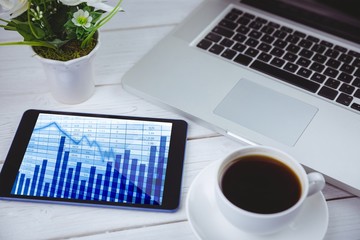 Composite image of tablet on desk