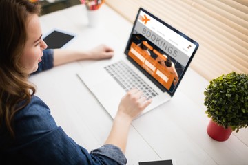 Composite image of woman using laptop