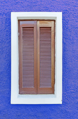 Big brown window on the blue wall