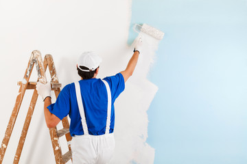 painter painting with paint roller - 101697747