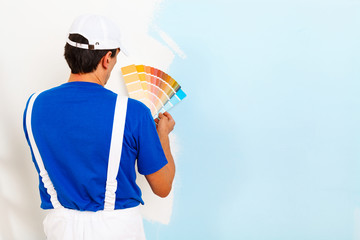 painter man looking a color palette - 101699346