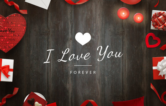 I love you message with gifts, hearts, candles on wooden table.