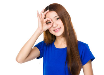 Woman with ok sign on eye