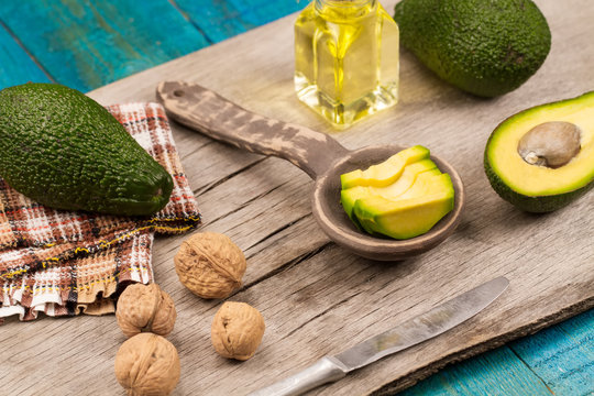fresh avocados on wooden background. Healthy food, diet. Vegetarian. Avocado oil