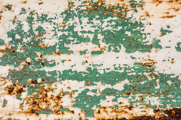 old white and green cracked paint on rusty metal surface
