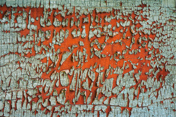 old green cracked paint on red rusty metal surface