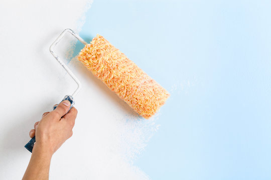 Close Up Of Painter Hand Painting A Wall