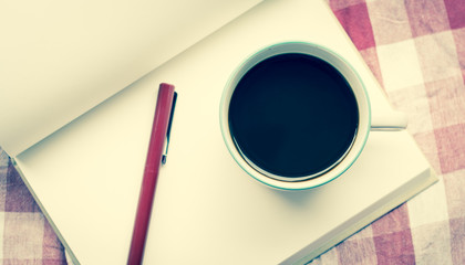 Coffee cup and notebook