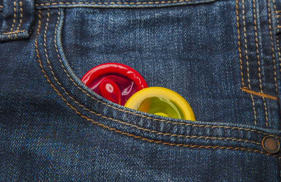colored condoms in a pocket of  jeans