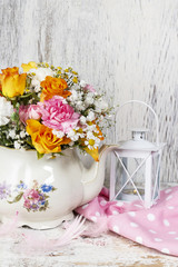 Obraz na płótnie Canvas Romantic bouquet of flowers in vintage kettle