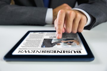 Composite image of businessman using digital tablet