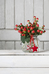Fototapeta na wymiar Bouquet of hypericum plants (twigs with red berries)